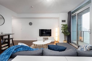 Living room featuring smart TV and wide glass doors for abundance of natural light