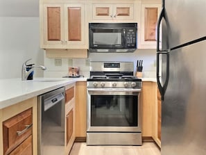Discover the perfect fusion of rustic charm and modern convenience in our kitchen, adorned with stylish appliances.
