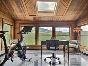 Boost productivity with a view: Our office space features a Peloton bike, allowing you to stay active while enjoying the breathtaking mountain vista. Get inspired by nature as you work towards your goals.