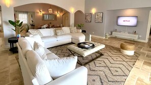 Different angle of the living room, with dining area in the back.