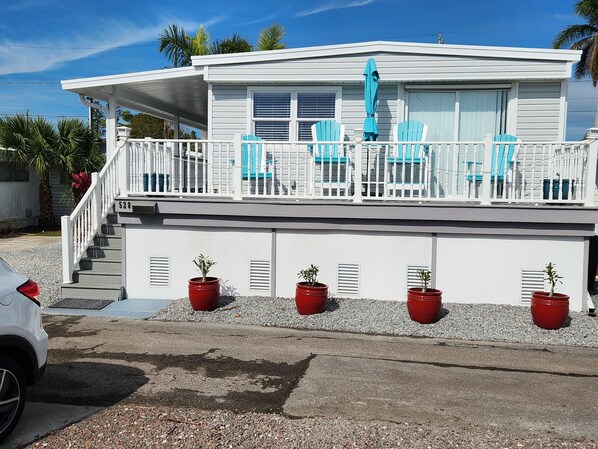 Wrap around deck, 6 steps up,  comfortable seating and a bay view. 