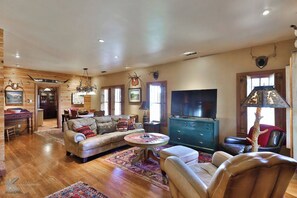 Embrace the great room where hides and antlers weave tales of wilderness and warmth.