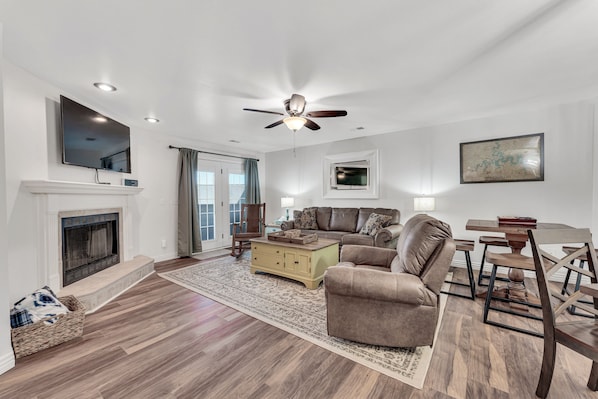 The living room leads to the private back patio for extra living space