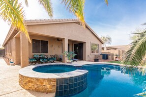 relaxing spa and covered patio with ceiling fan and misters