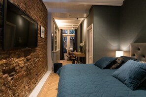 Big and comfy king sized bed with wall mounted TV