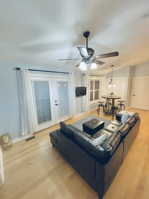 Living room with double doors opening onto back deck