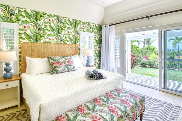 Tranquil king-sized bedroom with sliding door to lush garden.