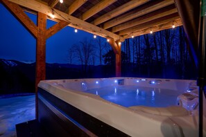 Unwind in a soothing hot tub under a starlit sky, enveloped in warmth and romance. 