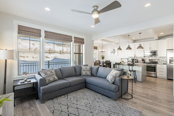 Living Room with Sectional Sofa, Smart TV, and Electric Fireplace