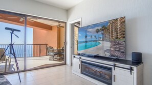 Large TV and an electric fireplace in the living room.