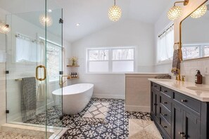 Primary bathroom with deep soak tub and rain shower. (1)