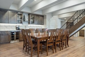 The beautiful wet bar, complete with wine fridge, promises to elevate your evenings with the perfect pour.