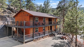 The hotel building has six units, a grill and a picnic table.