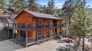 The hotel building has six cabins, a grill and a picnic table.