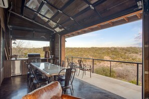 Dining area boasts an indoor-outdoor feel with a large garage door that opens.