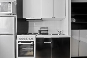 Kitchen with stove and full size fridge