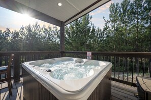 Take a relaxing soak in the hot tub on the deck with stunning views of the surrounding trees.