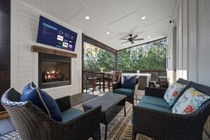 The deck features a Smart TV and gas fireplace to gather around for an outdoor movie night.