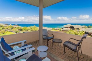 The living room seamlessly flows directly outdoors to the large, covered lanai