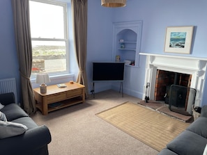 Living room with wood burning stove & satellite TV