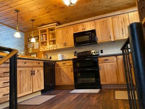 Misbehaven - Full Kitchen with Microwave, Dishwasher, Refrigerator, and Coffee Pot