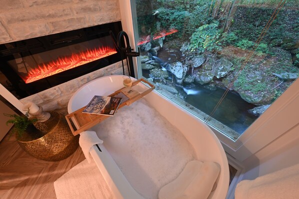 Spa like master bath with soaking tub & fireplace overlooking the gorgeous creek and falls!