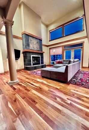 Large family room area with comfortable sectional sofa and flatscreen television