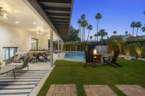 Backyard oasis and cozy lounge area awaits your moments of leisure. 