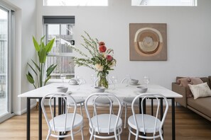 Charming dining area with a stylish table and comfortable seating, perfect for enjoying meals in a warm and inviting atmosphere.