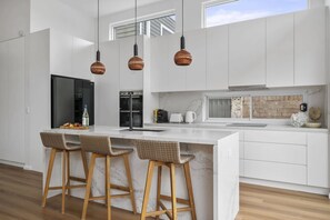 Sleek and contemporary kitchen with a stylish counter, perfect for casual dining or entertaining in effortless style.