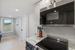 Kitchen with coffee maker, toaster, and all standard appliances, including dishwasher.