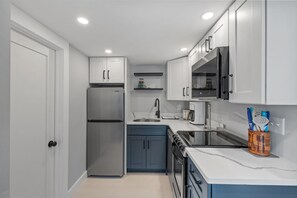 Kitchen with coffee maker, toaster, and all standard appliances, including dishwasher.