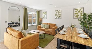 OPEN PLAN LIVING ROOM WITH DINING TABLE AND CHAIRS