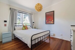 The spacious first bedroom features a queen-size bed and a TV for you to settle in with your favourite series.  