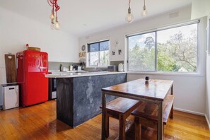 Dine inside at the timber six-seater table.