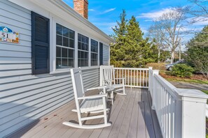 Front porch with rocking chairs to view the bay