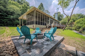 Gather around the fire pit and soak up the serenity of the riverfront setting. This cozy space is perfect for sharing stories, roasting marshmallows, and making memories — all just steps from the comfort of the screened porch and deck.