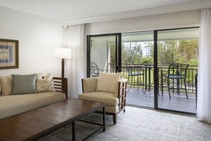 Enjoy the view from this bright living room that opens onto a scenic balcony.