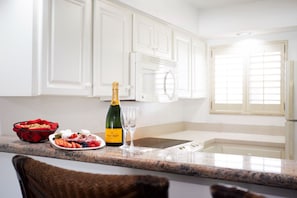 Intimate dining corner with champagne and treats, ready for a special celebration.