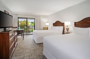 Spacious and serene, this bedroom offers a plush retreat with a view.