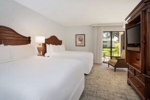 Cozy bedroom corner with a plush bed and classic furnishings for a touch of elegance.