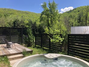 A relaxing private hot tub and deck with stunning mountain views await you right outside the bedroom doors. Each of our cabins has its own private hot tub. 