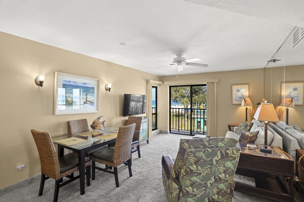 Open Floor Plan Living Room Dining Area With Balcony Access