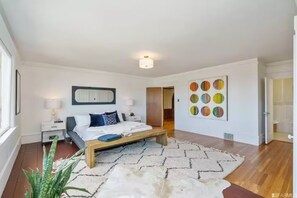 Our spacious room, featuring a king bed, large windows.