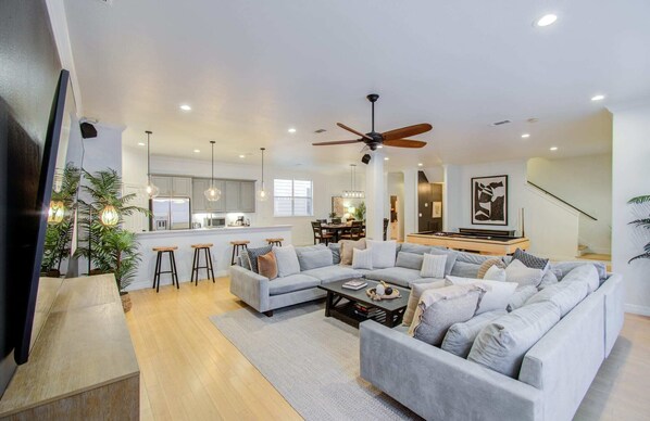 Packed full of entertainment and appeal, this open-concept layout makes for easy socializing no matter where your interests lie – in the kitchen, at the pool table, or on the couch!