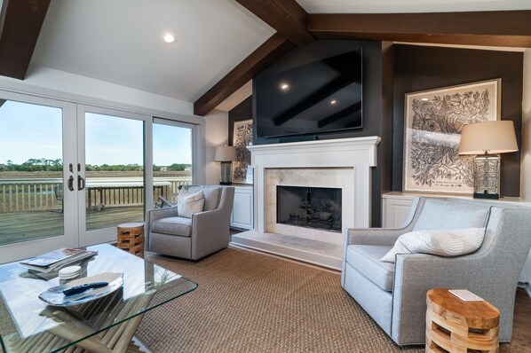 The great room has a living area with doors out to the deck