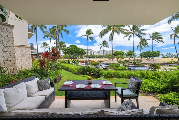 A tropical view on the lanai with elegant patio seating.