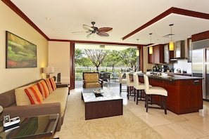 The inviting living area and kitchen with bar seating.