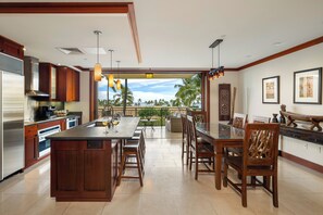The kitchen with bar seating and the dining area.