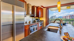 The kitchen has stainless steel appliances and island bar seating.